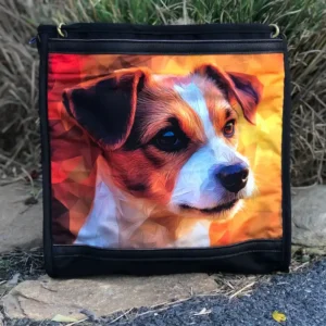 Custom black tote bag featuring a detailed illustration of a small puppy dog, resting on a stone ledge with a leather shoulder strap.