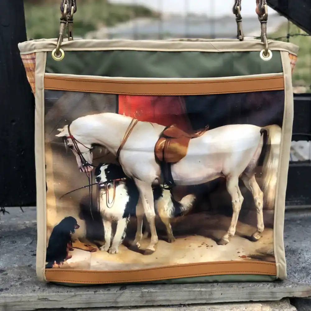 Custom tote bag featuring a detailed illustration of a white horse with saddle in a barn, resting on a stone ledge with a leather shoulder strap.