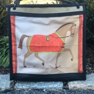 Custom black tote bag featuring a detailed illustration of a horse with a red coat, resting on a stone ledge with a leather shoulder strap.