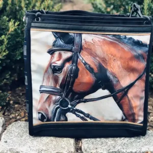 Custom black tote bag featuring a detailed illustration of a horse's head, resting on a stone ledge with a leather shoulder strap.