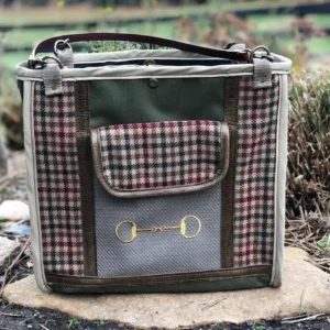 Custom plaid tote bag, resting on a stone ledge with a leather shoulder strap.
