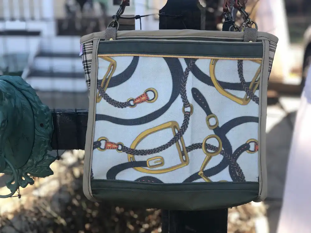 Custom green tote bag featuring a detailed illustration of horse straps, with a leather shoulder strap.