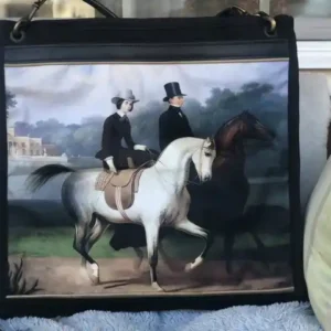 Custom tote bag featuring a detailed illustration of two horses and riders, with a leather shoulder strap.