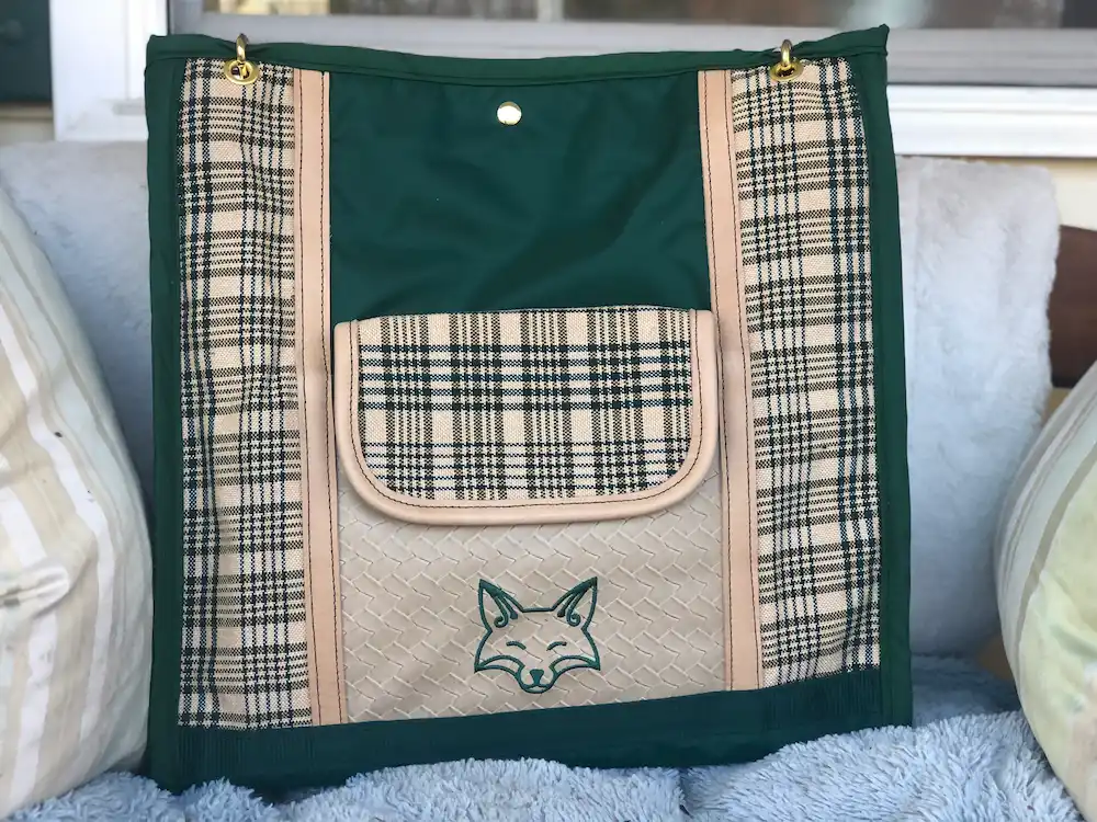 Custom green plaid tote bag, with a leather shoulder strap.