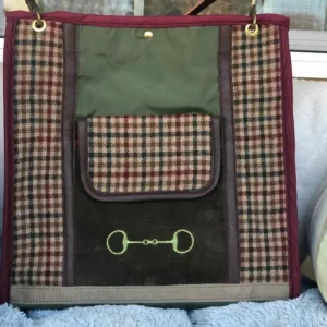 Custom plaid tote bag, resting on a couch with a leather shoulder strap.