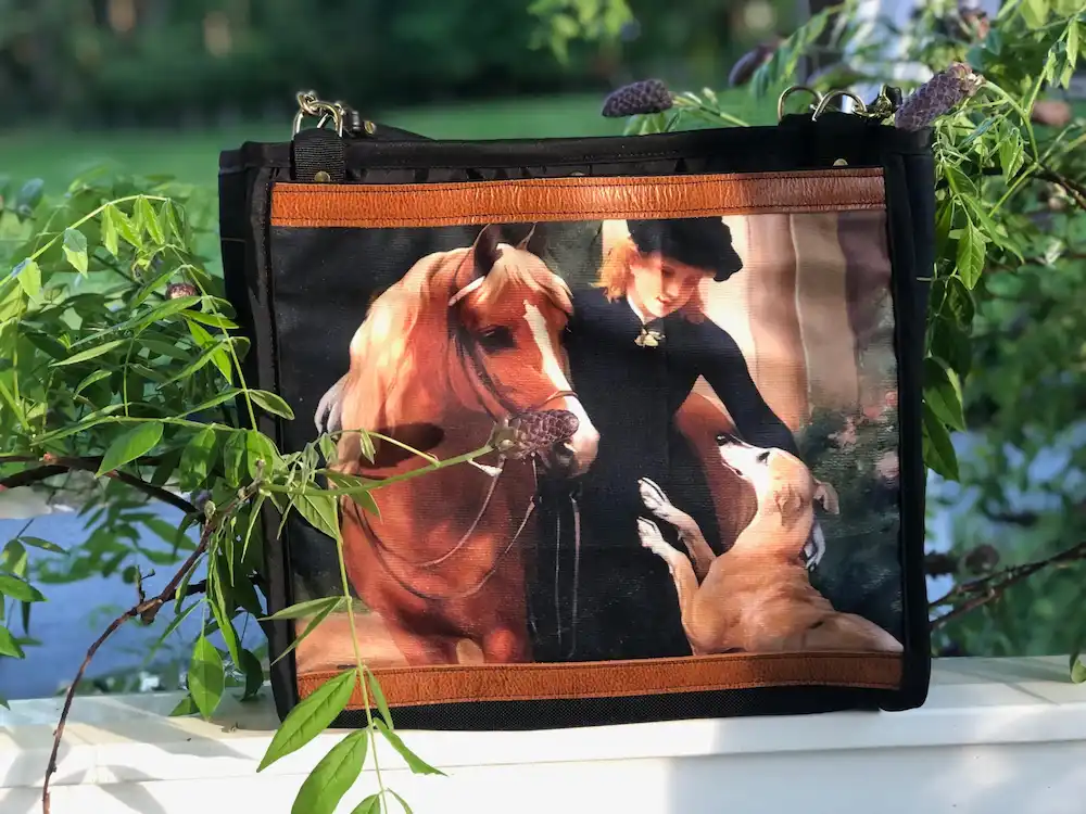 Custom tote bag featuring a detailed illustration of a horse, lady in dress and dog, with a leather shoulder strap.